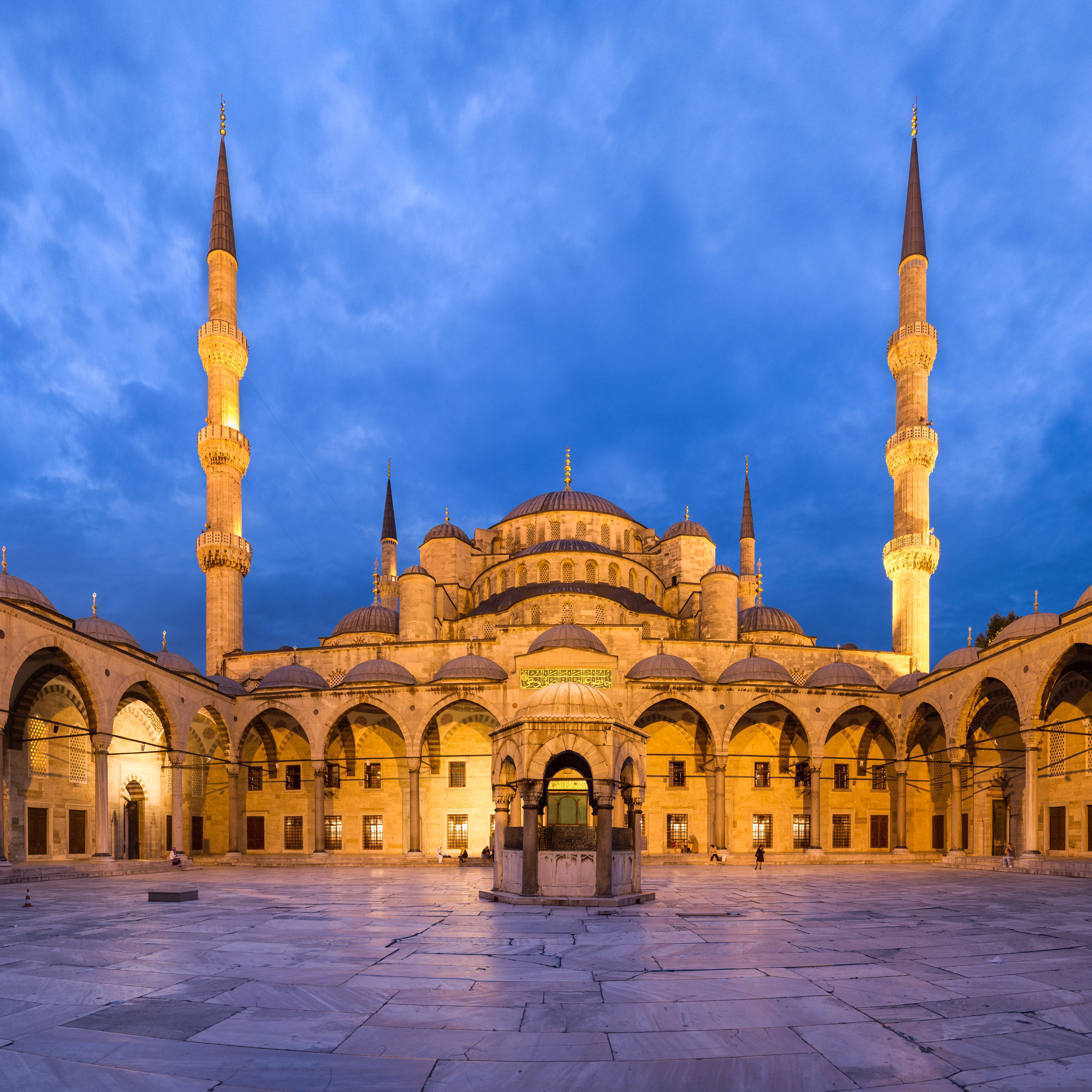 Panoramic view of the courtyard of the Blue Mosque, in Istanbul, Turkey. The courtyard has a square shape, but the mercator projection necessary to squeeze all the field of view into the frame bends the horizontal lines. Panorama created with Hugin.
